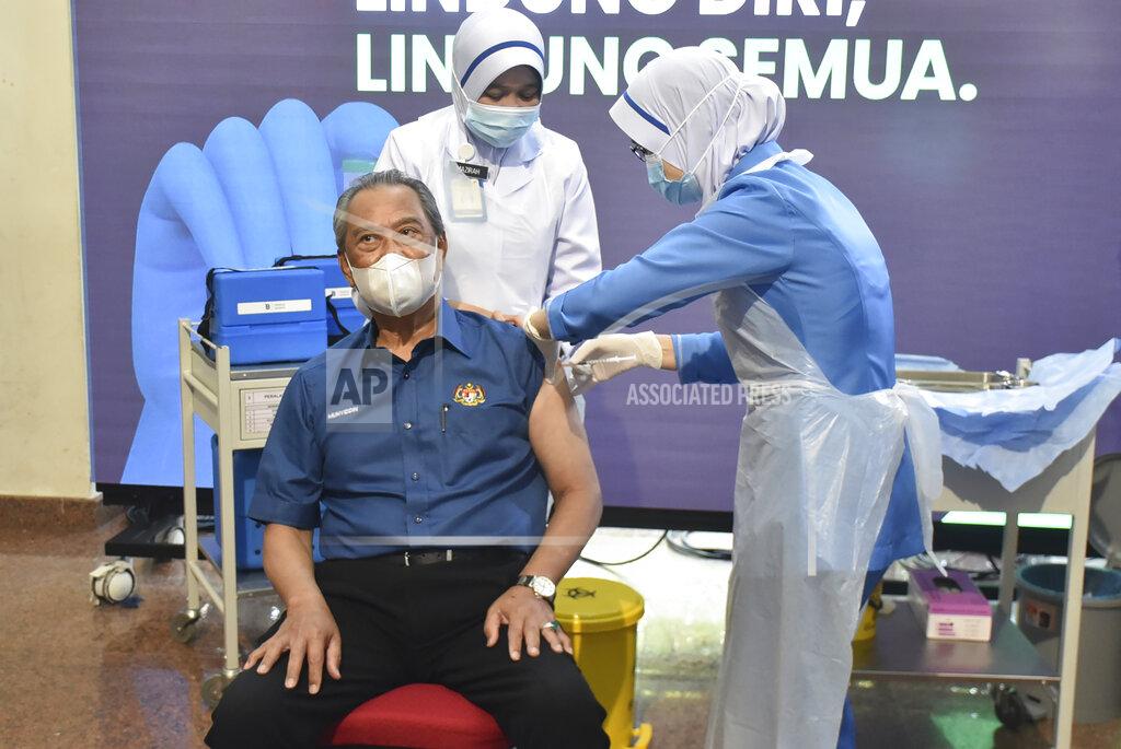 Muzzafar Bin Kasim Malaysia's Prime Minister Muhyiddin Yassin receives the first dose of the Pfizer-BioNTech COVID-19 vaccine at a clinic in Putrajaya, Malaysia, Wednesday, Feb. 24, 2021. (Malaysia Health Ministry via AP)