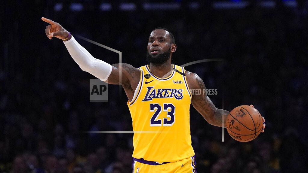 Mark J. Terrill FILE - In this March 6, 2020, file photo, Los Angeles Lakers forward LeBron James gestures to teammates during the second half of an NBA basketball game against the Milwaukee Bucks in Los Angeles. James was announced Saturday, Dec. 26, as the winner of The Associated Press’ Male Athlete of the Year award for a record-tying fourth time.(AP Photo/Mark J. Terrill, File)