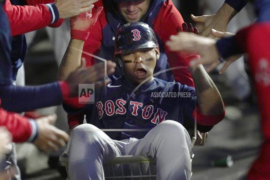 Charles Rex Arbogast Boston Red Sox's Rafael Devers celebrates his home run in the dugout during the fourth inning of a baseball game against the Chicago White Sox Tuesday, May 24, 2022, in Chicago. (AP Photo/Charles Rex Arbogast)