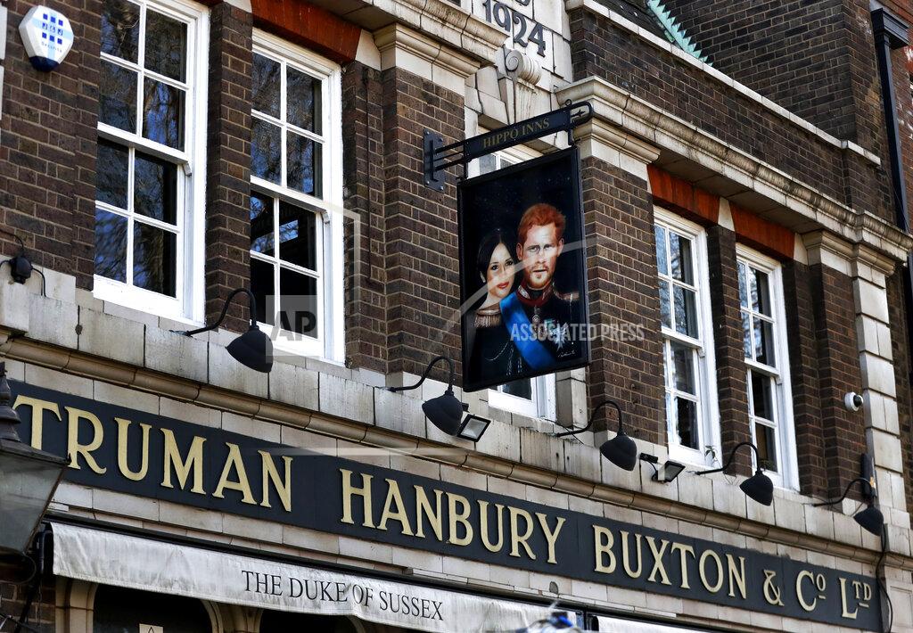 Frank Augstein A sign depicting the image of Britain's Prince Harry and his wife Meghan, hangs outside the Duke of Sussex pub near Waterloo station, London, Tuesday March 9, 2021. Prince Harry and Meghan's explosive TV interview has divided people around the world, rocking an institution that is struggling to modernize with claims of racism and callousness toward a woman struggling with suicidal thoughts. (AP Photo/Frank Augstein)