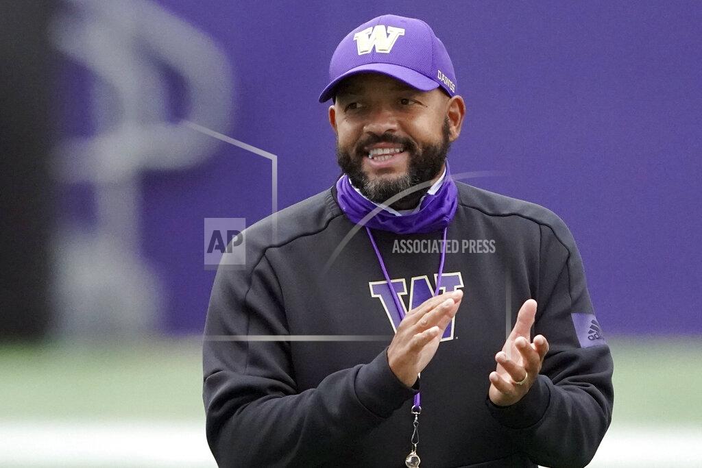 Ted S. Warren FILE - In this Friday, Oct. 16, 2020, file photo, Washington head coach Jimmy Lake watches his team during NCAA college football practice in Seattle. The season opener between California and Washington has been canceled following a request from the Golden Bears due to a positive coronavirus test for one of their players. (AP Photo/Ted S. Warren, File)