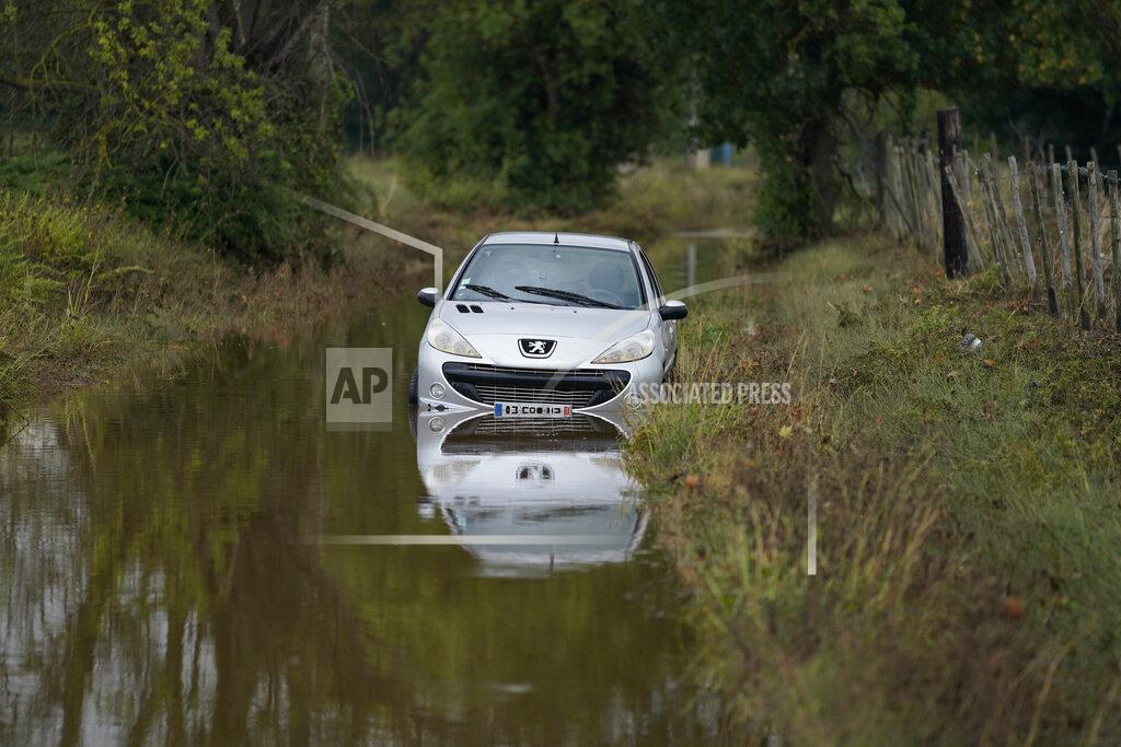 Daniel Cole A car is seen flooded in Bernis, southern France,Wednesday, Sept. 15, 2021 in Paris. Emergency workers rescued or evacuated hundreds of people in southern France as flash flooding abruptly turned roads and fields into rivers and lakes. As new heavy rainfall threatened the area Wednesday, the emergency service for the Gard region said rescuers were searching for at least one person reported missing after the Tuesday evening flood. (AP Photo/Daniel Cole)