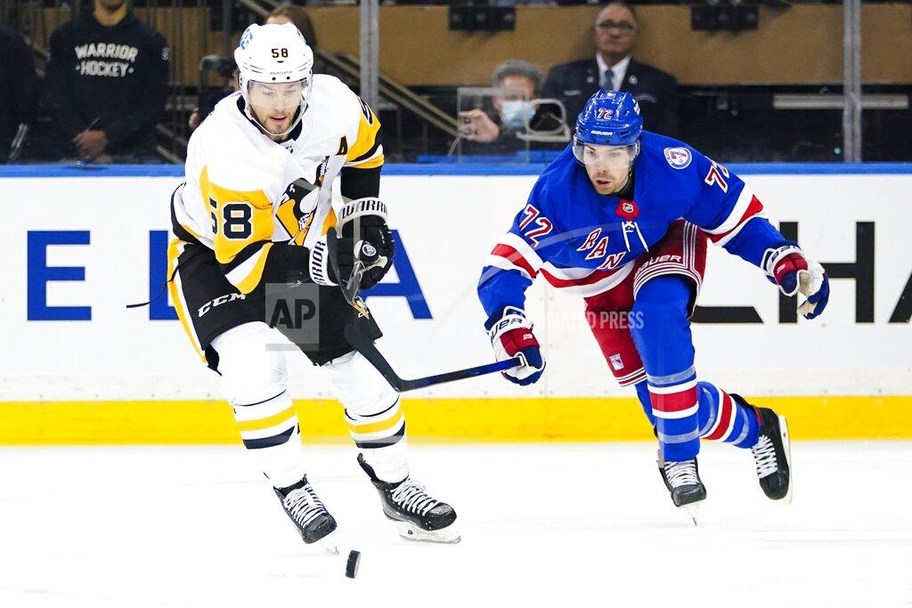 Frank Franklin Ii Pittsburgh Penguins' Kris Letang (58) fights for control of the puck with New York Rangers' Filip Chytil (72) during the first period of Game 5 of an NHL hockey Stanley Cup first-round playoff series Wednesday, May 11, 2022, in New York. (AP Photo/Frank Franklin II)
