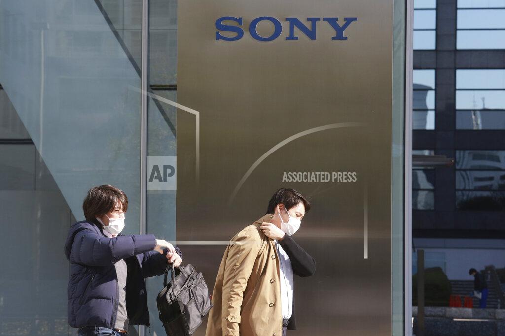 Koji Sasahara People walk in front of the headquarters of Sony Corp. in Tokyo, Wednesday, Feb. 3, 2021. Sony Corp. reports its fiscal third quarter profit jumped 62%, positioning the Japanese entertainment and electronics giant for a record annual profit as its bottom line got a healthy boost from its mega-hit animation film “Demon Slayer.” (AP Photo/Koji Sasahara)