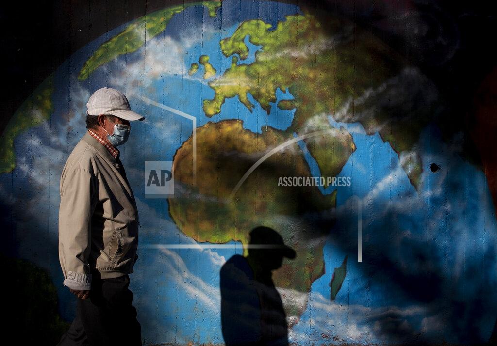 Manu Fernandez A man walks past graffiti at Orcasitas neighbourhood in Madrid, Spain, Monday, Sept. 28, 2020. Spain has become the first western Europe to accumulate more than 1 million confirmed infections as the country of 47 million inhabitants struggles to contain a resurgence of the coronavirus. (AP Photo/Manu Fernandez)