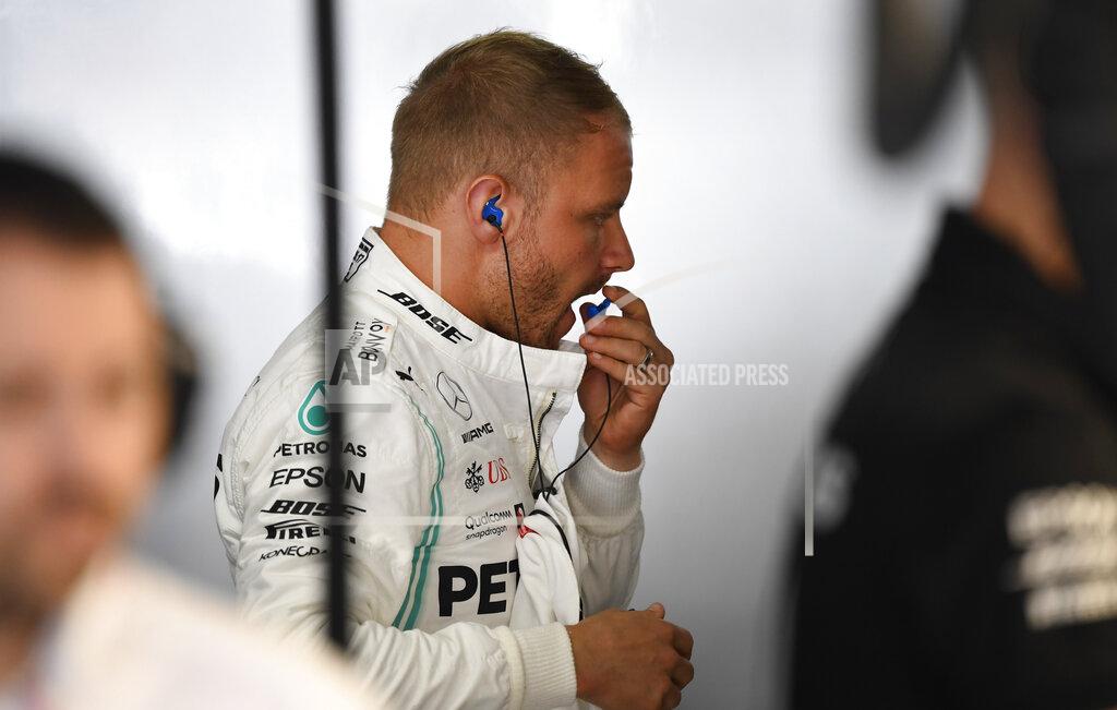 Jens Meyer Mercedes driver Valtteri Bottas of Finland, center, prepares for the first practice session at the Hockenheimring racetrack in Hockenheim, Germany, Friday, July 26, 2019. The German Formula One Grand Prix will be held on Sunday. (AP Photo/Jens Meyer)