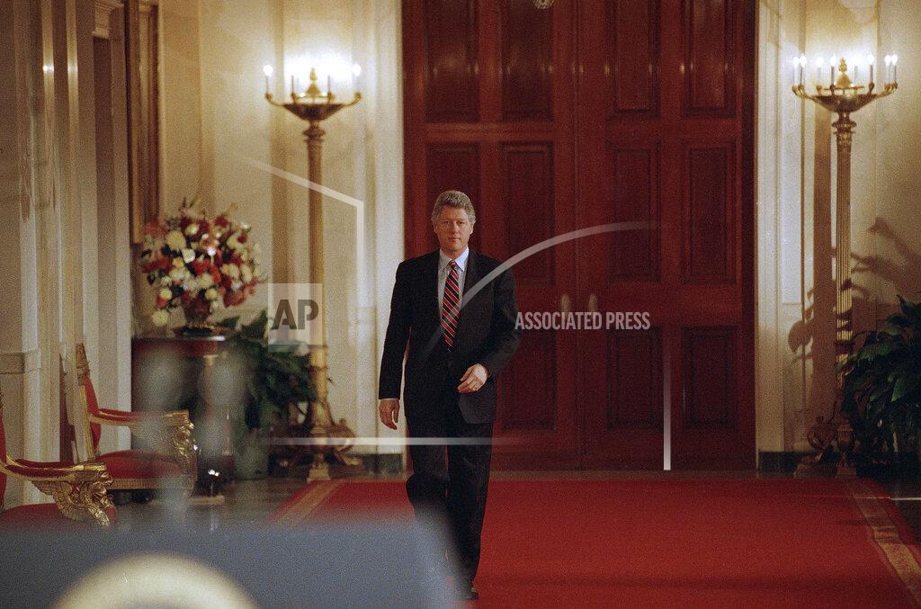 Ron Edmonds FILE - In this March 23, 1993, file photo, President Bill Clinton walks through the Grand Foyer to the East Room of the White House in Washington going to his first formal news conference. (AP Photo/Ron Edmonds, File)