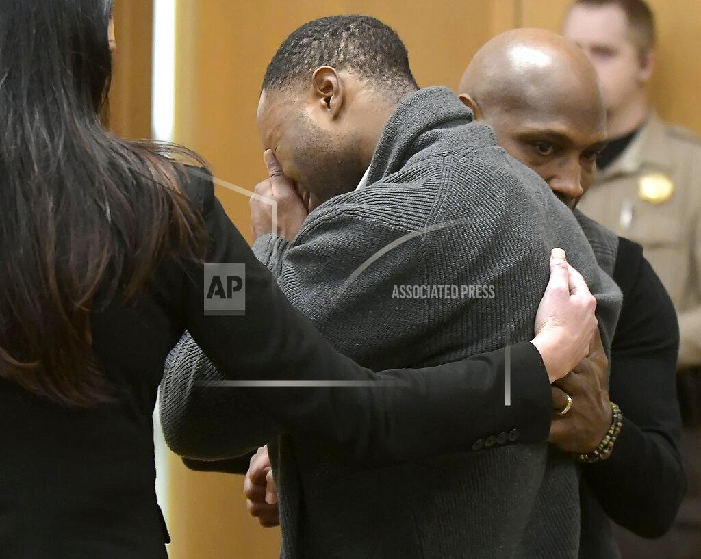 Eli Lucero Torrey Green cries while being consoled by defense attorney Skye Lazaro, left, and private investigator E. Christian Warmsley as a jury finds him guilty of eight charges including five counts of rape and a charge sexual battery in connection to reports from six women accusing him of sexual assault while he was a football player at Utah State University, Friday, Jan.18, 2019 in Brigham City, Utah. (Eli Lucero/Herald Journal via AP, Pool)