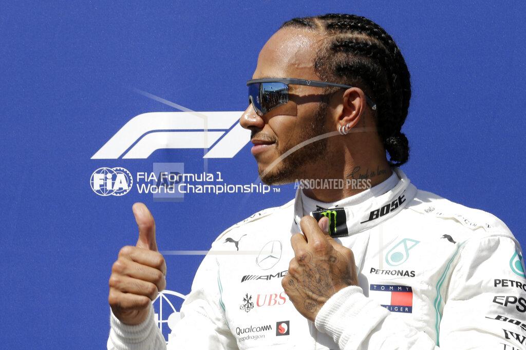 Claude Paris Mercedes driver Lewis Hamilton of Britain celebrates after he clocked the fastest time during the qualifying session at the Paul Ricard racetrack in Le Castellet, southern France, Saturday, June 22, 2019. The French Formula One Grand Prix will be held on Sunday. (AP Photo/Claude Paris)