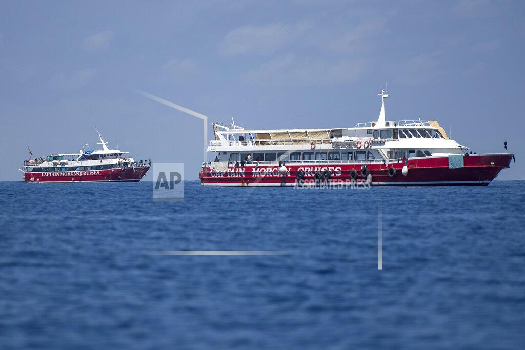 Rene' Rossignaud In this photo taken Tuesday, June 2, 2020, two of the tourist boats used by the Maltese government to host migrants some 20 kilometers from Malta. More than 400 migrants are living aboard pleasure cruise vessels, bobbing in the sea off Malta, many of them for weeks now. Rescued from human traffickers’ unseaworthy boats in several operations in the central Mediterranean since late April, the migrants, along with the Maltese government, are waiting for European Union countries to offer to take them. (AP Photo/Rene' Rossignaud)
