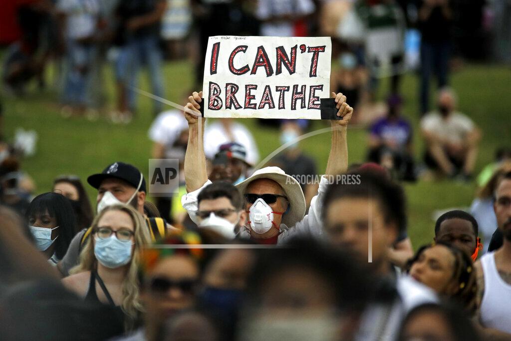 Charlie Riedel A man holds up a sign as he listens to the Rev. Al Sharpton address the crowd at a Juneteenth rally in Tulsa, Okla., Friday, June 19, 2020. Juneteenth marks the day in 1865 when federal troops arrived in Galveston, Texas, to take control of the state and ensure all enslaved people be freed, more than two years after the Emancipation Proclamation. (AP Photo/Charlie Riedel)