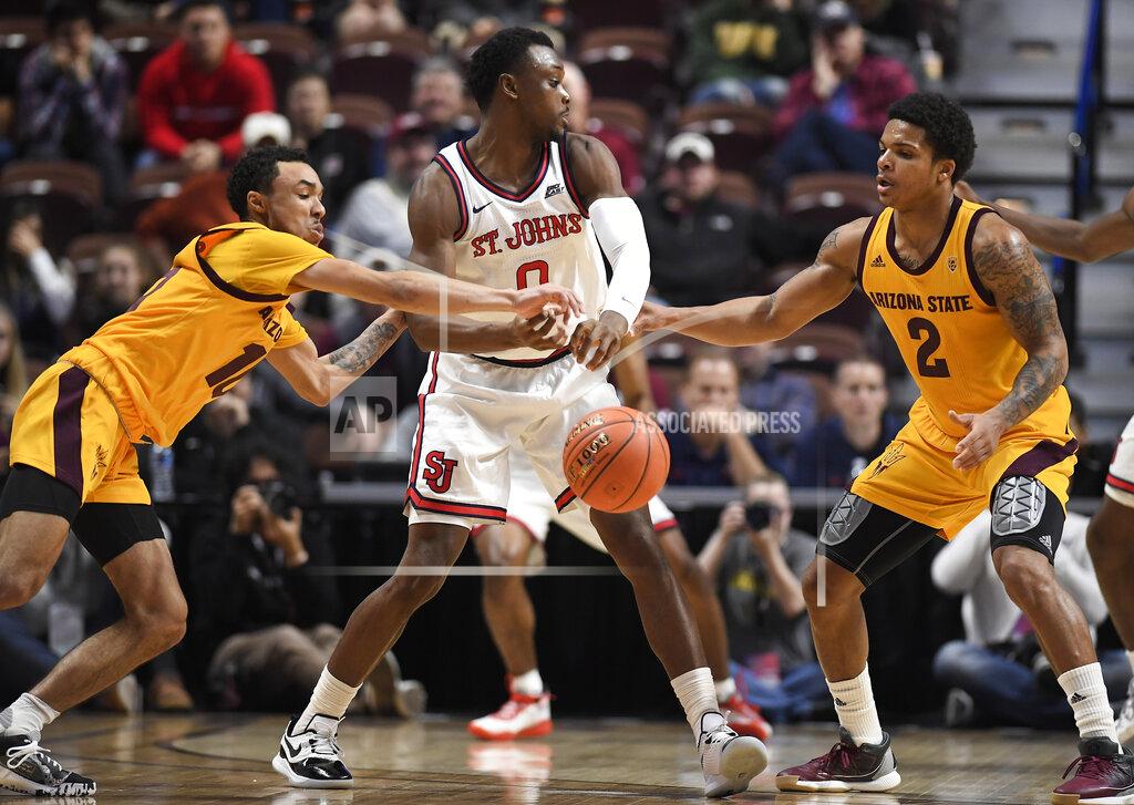 Jessica Hill Arizona State's Jaelen House, left, knocks the ball from St. John's Mustapha Heron, center, as Arizona State's Rob Edwards, right, defends during the first half of an NCAA college basketball game, Saturday, Nov. 23, 2019, in Uncasville, Conn. (AP Photo/Jessica Hill)
