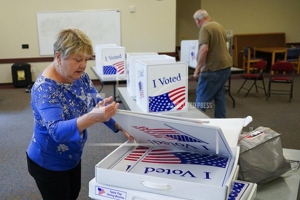 Keith Srakocic Cecelia Peterson, the majority inspector for the Cranberry West 5 voting precinct, left, and clerk Fred Peterson set up some of the folding voting booth dividers in one of the rooms in the Cranberry Township Municipal Center that will be used for voting in Tuesday's Pennsylvania Primary Election, Monday, May 16, 2022, in Cranberry Township, Butler County, Pa. (AP Photo/Keith Srakocic)