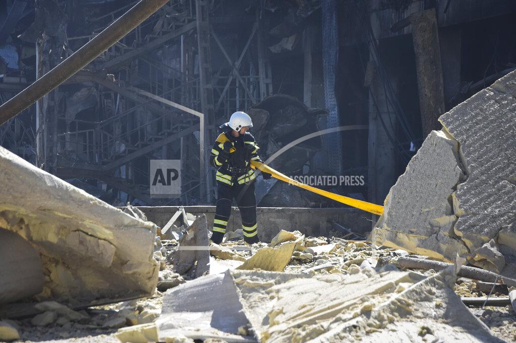 Max Pshybyshevsky An Ukrainian firefighter works near a destroyed building on the outskirts of Odesa, Ukraine, Tuesday, May 10, 2022. The Ukrainian military said Russian forces fired seven missiles a day earlier from the air at the crucial Black Sea port of Odesa, hitting a shopping center and a warehouse. (AP Photo/Max Pshybyshevsky)