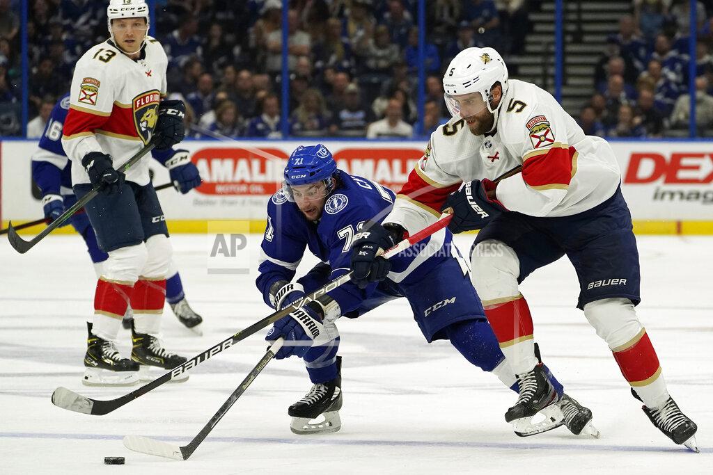 Chris O'MEara Tampa Bay Lightning center Anthony Cirelli (71) works the puck past Florida Panthers defenseman Aaron Ekblad (5) during the second period of an NHL hockey game Tuesday, Oct. 19, 2021, in Tampa, Fla. (AP Photo/Chris O'Meara)