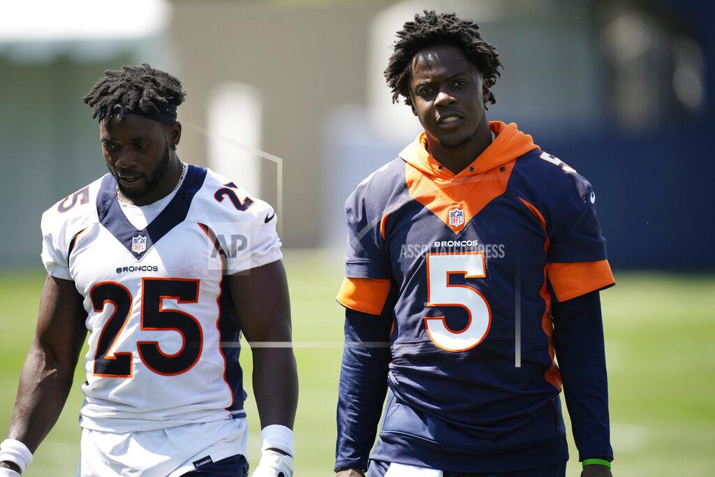 Denver Broncos running back Melvin Gordon, left, chats with quarterback Teddy Bridgewater after taking part in drills at NFL football training camp, Wednesday, July 28, 2021, in Englewood, Colo. (AP Photo/David Zalubowski)