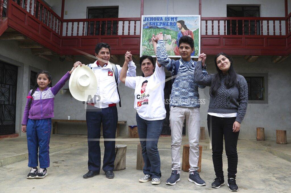 Martin Mejia Free Peru party presidential candidate Pedro Castillo, second from left, poses for a photo with his family, from left, daughter Alondra 9, son Arnold 16, wife Lilia Paredes, and sister-in-law Yenifer Paredes, before leaving their home to campaign in Chugur, Peru, Friday, April 16, 2021. Castillo, a rural teacher, who has proposed rewriting Peru's constitution and deporting all immigrants living in the country illegally who commit crimes, will face rival candidate Keiko Fujimori in the June 6 presidential run-off election. (AP Photo/Martin Mejia)