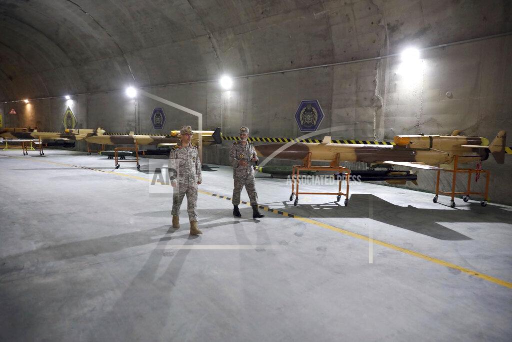 Uncredited In this photo released on Saturday, May 28, 2022 by website of the Iranian Army, Chief of the General Staff of the Armed Forces Gen. Mohammad Hossein Bagheri, left, and Commander of the Army Gen. Abdolrahim Mousavi talk while visiting an underground drone base tunnel of the Army in the heart of the country's western Zagros Mountains. Iranian state television's report said Saturday, the tunnel was some 100 meters (330 feet) underground and was home to the Kaman-22 and Fotros drones, both capable of carrying cruise missiles. (Iranian Army via AP)
