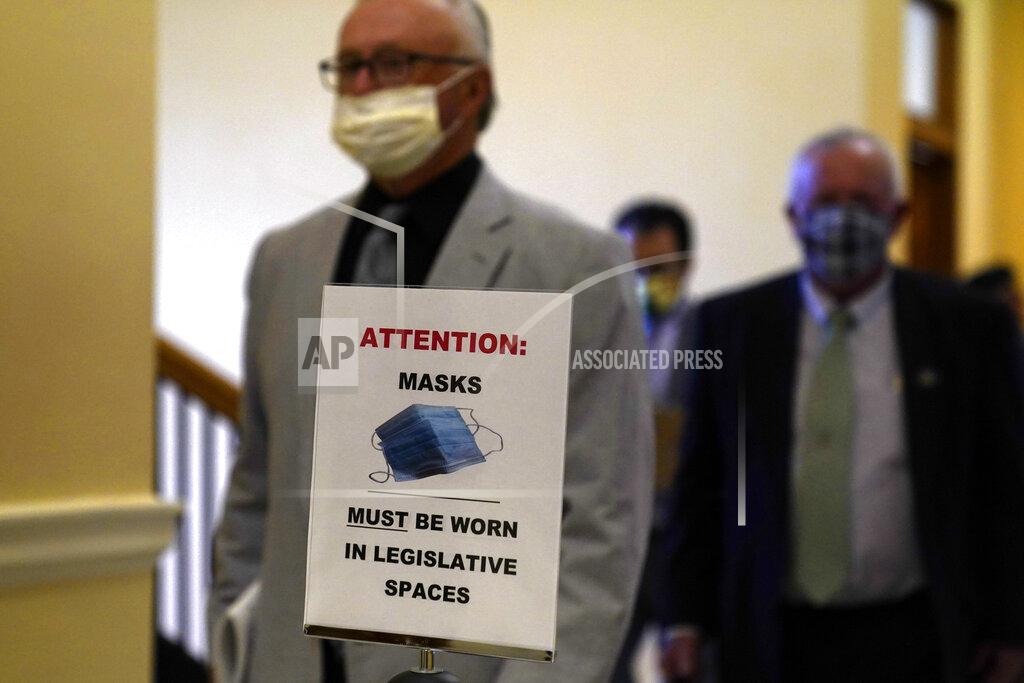 Robert F. Bukaty Signs remind legislators to wear face coverings during the first legislative session in the State House since the proceedings were moved to the more spacious Augusta Civic Center, Wednesday, June 2, 2021, in Augusta, Maine. (AP Photo/Robert F. Bukaty)