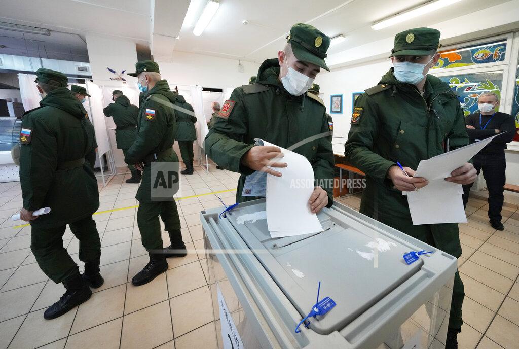 Dmitri Lovetsky Russian Army soldiers cast their ballots during the State Duma, the Lower House of the Russian Parliament and local parliaments elections at a polling station outside St. Petersburg, Russia, Friday, Sept. 17, 2021. Russia has begun three days of voting for a new parliament that is unlikely to change the country's political complexion. There's no expectation that United Russia, the party devoted to President Vladimir Putin, will lose its dominance in the State Duma. (AP Photo/Dmitri Lovetsky)