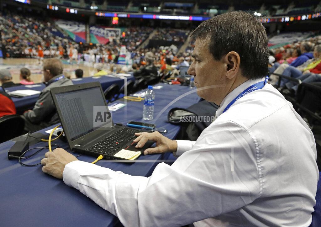 Chuck Burton In this photo taken March 9, 2019 Precision Time inventor Mike Costabile, a former referee, keeps track of a log of the system during the second half of an Atlantic Coast Conference women's tournament basketball game in Greensboro, N.C. The Precision Time system created more than two decades ago by Costabile currently is used at nearly every level of the sport, including the NBA and college basketball's NCAA Tournament. Costabile estimates the ability to stop the clock automatically on a referee's whistle can save roughly 90 seconds formerly lost to reaction time when timekeepers manually stopped the clock. (AP Photo/Chuck Burton)