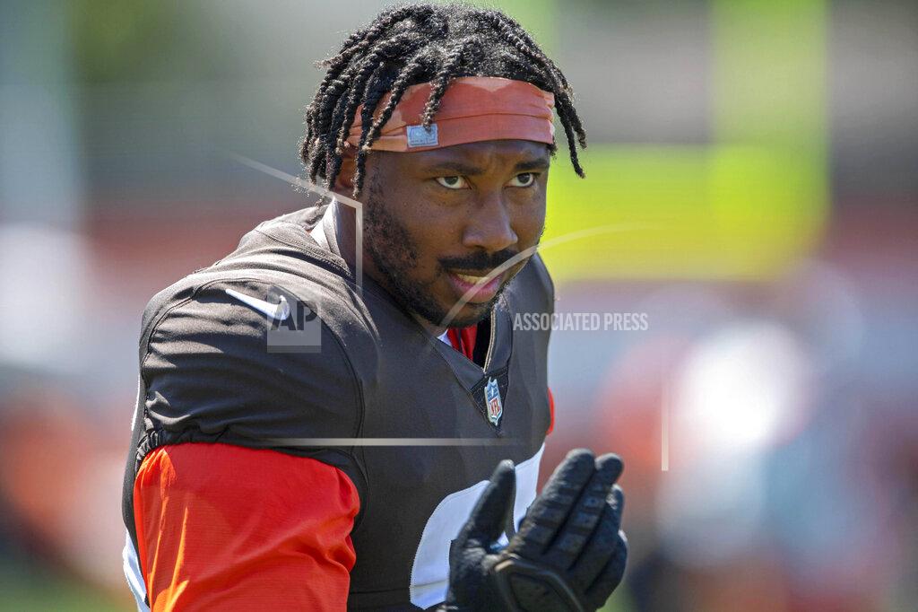 Cleveland Browns defensive linemen Myles Garrett (95) encourages the fans to cheer during an NFL football practice in Berea, Ohio, Wednesday, Aug. 4, 2021. (AP Photo/David Dermer)