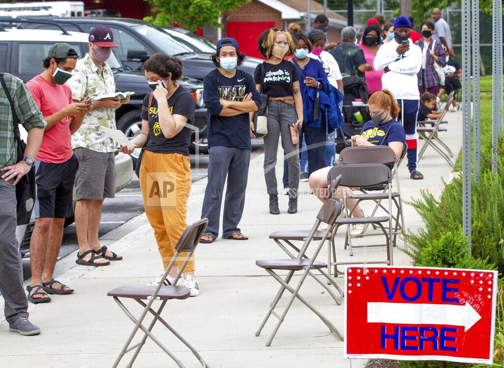 Steve Schaefer Voters wait in a line that stretched around the Metropolitan Library in Atlanta, Georgia, Tuesday, June 9, 2020. (Steve Schaefer/Atlanta Journal-Constitution via AP)