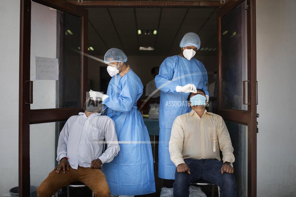 Health workers conduct COVID-19 antigen tests at an Agricultural Institute in New Delhi, India, Thursday, Oct. 8, 2020. India is the world's second most coronavirus affected country after the United States. (AP Photo/Altaf Qadri)