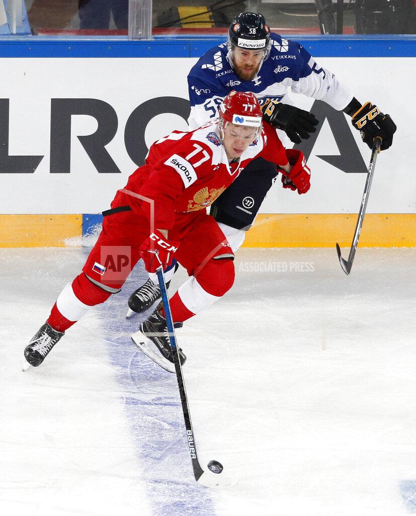 Dmitri Lovetsky FILE - In this Sunday, Dec. 16, 2018, file photo, Russia's Kirill Kaprizov (77) battles Finland's Jani Hakanpaa (58) during the Channel One Cup ice hockey match in St. Petersburg, Russia. Bonding between veterans and youngsters has been a time-honored tradition in hockey. Older players routinely invite rookies to live with them during their first year. This season, NHL protocols aimed at curbing the spread of COVID-19 could make team-building more difficult. (AP Photo/Dmitri Lovetsky, File)