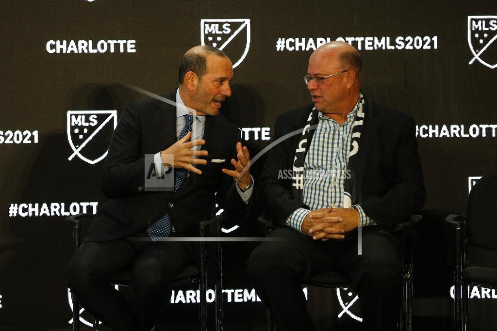 Nr Major League Soccer Commissioner Don Garber, left, and Charlotte MLS owner David Tepper talk during the announcement that an MLS team, owned by Tepper, will begin play Charlotte in 2021 at an event in Charlotte, N.C., Tuesday, Dec. 17, 2019. (AP Photo/Nell Redmond