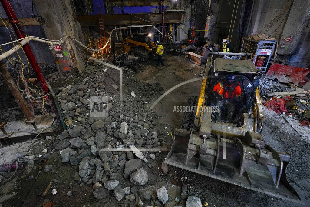 Construction workers clear out debris from the demolition of the original building at TSX Broadway under construction, Thursday, Oct. 29, 2020, in New York's, Times Square. The 46-story mixed-use property will house 75,000 square feet of retail space, a a 4,000-square-foot performance venue including an outdoor stage, an outdoor food and beverage terrace and a luxury hotel. U.S. construction spending rose 0.3% in September, the fourth straight monthly gain after a coronavirus-caused spring swoon. (AP Photo/Mary Altaffer)
