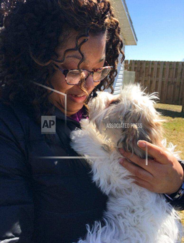 Uncredited In a photo provided by Candace Croney, Croney holds her dog, Desi, in April 2019, in Indiana. “If we think how much time most of our pets prior to the pandemic typically would spend without people around to 24 hours a day, seven days a week, it’s quite a lot,” says Croney, a Purdue University professor who teaches about animal behavior. (Courtesy of Candace Croney via AP)