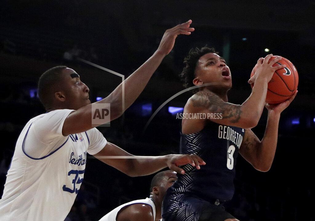 Julio Cortez Georgetown guard James Akinjo (3) goes up for a shot against Seton Hall center Romaro Gill (35) during the second half of an NCAA college basketball game in the Big East men's tournament, Thursday, March 14, 2019, in New York. Seton Hall won 73-57. (AP Photo/Julio Cortez)