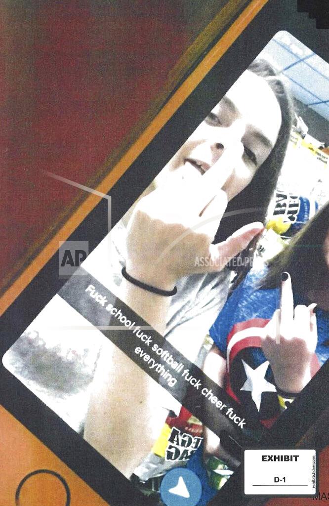Uncredited EDS NOTE: OBSCENITY - This photo provided by the American Civil Liberties Union, which was presented as evidence to the U.S. Supreme Court, shows a screenshot of a Snapchat post by Brandi Levy, left, in which Levy and her classmate raise their middle fingers as they pose in a convenience store in Mahonoy City, Pa., above a profanity-laced message written by Levy. The posting has ended up before the Supreme Court in the most significant case on student speech in more than 50 years. At issue in arguments to be heard Wednesday, April 28, 2021, via telephone, is whether public schools can discipline students over something they say off-campus. (Brandi Levy/American Civil Liberties Union via AP)