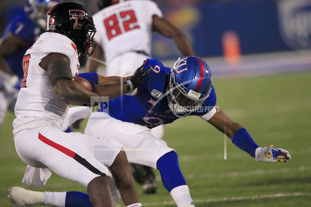 Orlin Wagner Texas Tech running back SaRodorick Thompson, left, stiff-arms Kansas linebacker Najee Stevens-McKenzie (9) during the first half of an NCAA college football game in Lawrence, Kan., Saturday, Oct. 26, 2019. (AP Photo/Orlin Wagner)