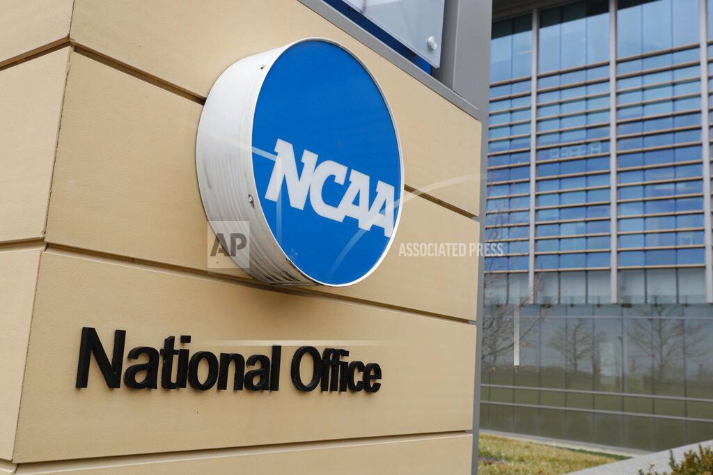 Michael Conroy FILE - Signage at the headquarters of the NCAA is viewed in Indianapolis, March 12, 2020. By trying to limit how much schools can help college athletes cashing in on their fame, the NCAA seems to have inadvertently opened the door for boosters to get a foothold in a burgeoning market. (AP Photo/Michael Conroy, File)