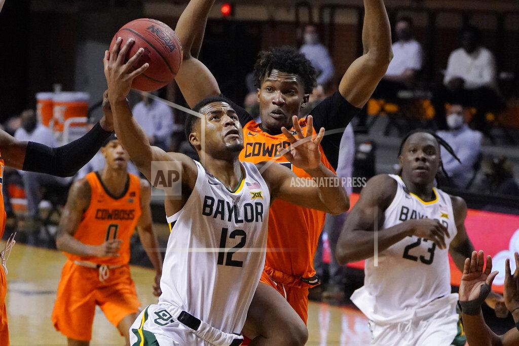 Sue Ogrocki Baylor guard Jared Butler (12) goes to the basket in front of Oklahoma State forward Matthew-Alexander Moncrieffe, rear, in the first half of an NCAA college basketball game Saturday, Jan. 23, 2021, in Stillwater, Okla. (AP Photo/Sue Ogrocki)