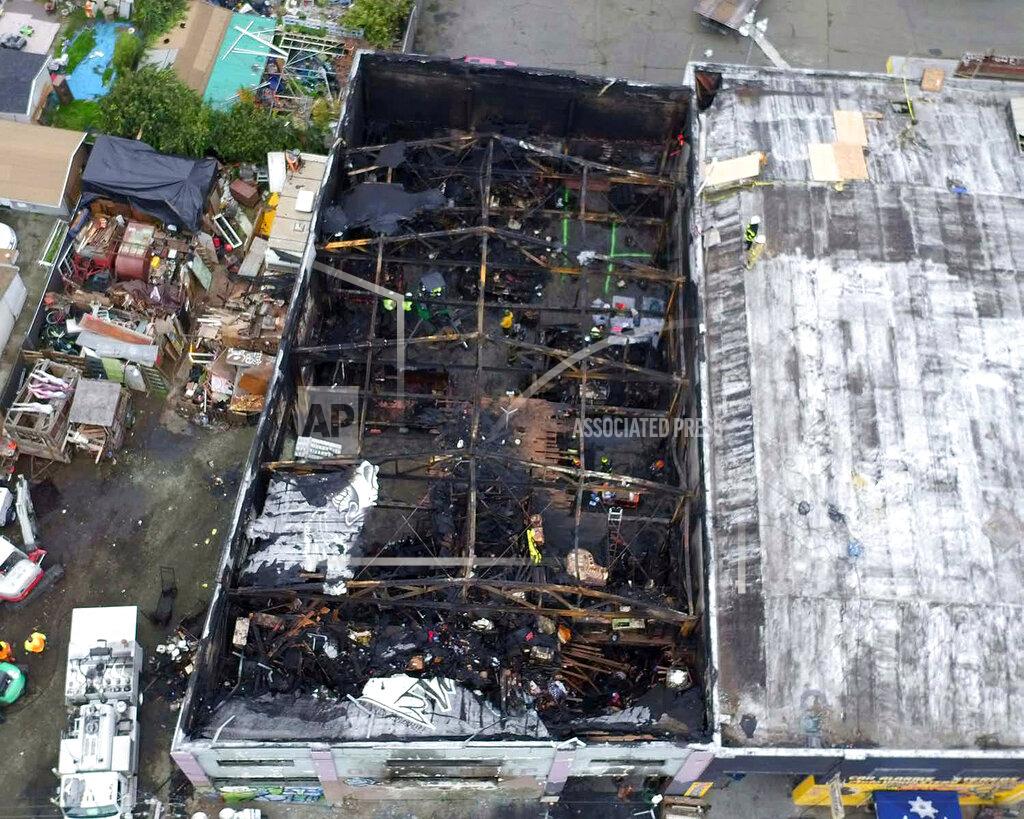 Uncredited FILE - This undated file photo provided by the City of Oakland shows the burned warehouse after the deadly fire that broke out on Dec. 2, 2016, in Oakland, Calif. Family members of the 36 people killed when a fire broke out at a San Francisco warehouse during a music event urged a judge Monday, March 8, 2021, to impose the toughest sentence for Derick Almena, the master tenant of the building, or reject a plea deal he struck with prosecutors to avoid a second trial. (City of Oakland via AP, File)