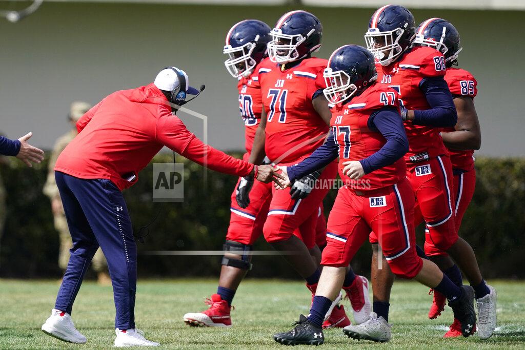 Rogelio V. Solis Coach Deion Sanders congratulates his team as they come off the field during the first half of an NCAA college football game against Edward Waters in Jackson, Miss., Sunday, Feb. 21, 2021. The game marked the coaching debut of Sanders. (AP Photo/Rogelio V. Solis)