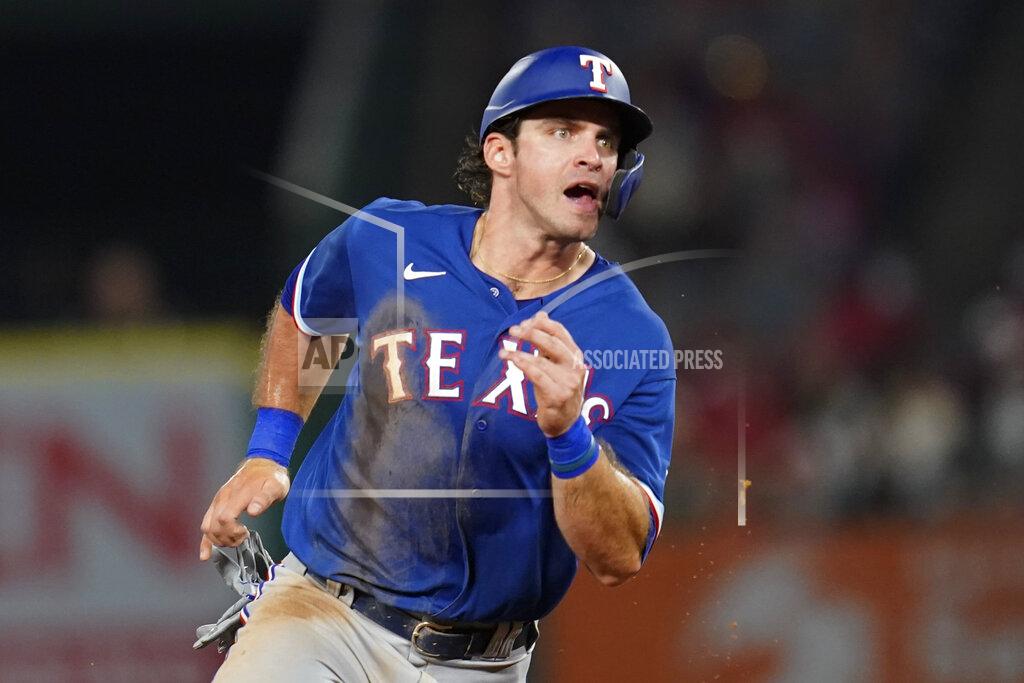 Ashley Landis Texas Rangers' DJ Peters rounds second base as Nick Solak doubles during the fourth inning of a baseball game against the Los Angeles Angels Friday, Sep. 3, 2021, in Anaheim, Calif. (AP Photo/Ashley Landis)