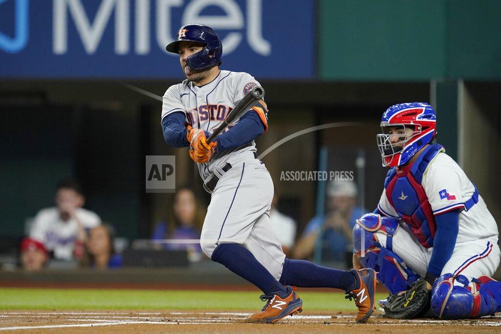 Tony Gutierrez Houston Astros' Jose Altuve follows through on a single next to Texas Rangers catcher Jose Trevino during the first inning of a baseball game in Arlington, Texas, Tuesday, Sept. 14, 2021. (AP Photo/Tony Gutierrez)