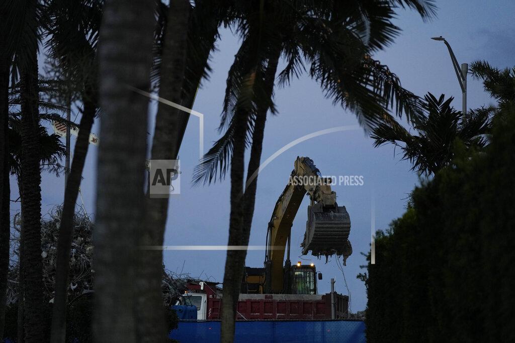 Rebecca Blackwell FILE - In this July 15, 2021 file photo, an excavator clears rubble at the site of the Champlain Towers South condo building collapse and demolition in Surfside, Fla. Firefighters have officially ended their search for bodies in the debris of the collapsed Surfside condo building, Friday, July 23. But police and forensic specialists continue working to identify human remains recovered from the disaster. (AP Photo/Rebecca Blackwell, File)