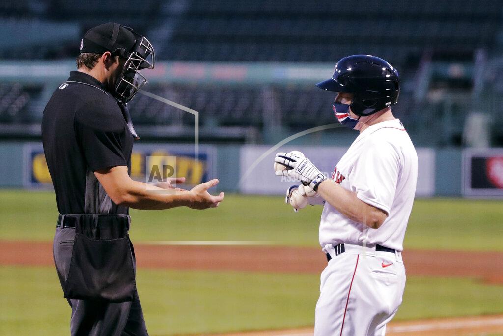 Charles Krupa Boston Red Sox batboy Chris Cundiff, right, brings fresh baseballs to home plate umpire Adam Beck during an exhibition baseball game agains the Toronto Blue Jays, Tuesday, July 21, 2020, at Fenway Park in Boston. (AP Photo/Charles Krupa)