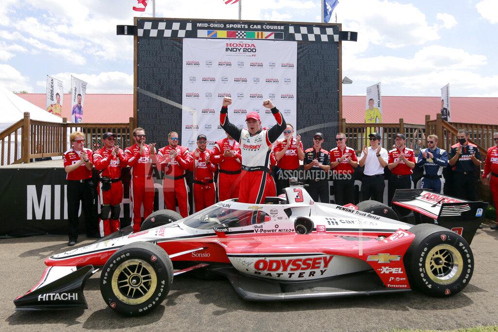 Tom E. Puskar Scott McLaughlin, center, celebrates in Victory Circle after winning an IndyCar auto race at Mid-Ohio Sports Car Course in Lexington, Ohio, Sunday, July 3, 2022. (AP Photo/Tom E. Puskar)
