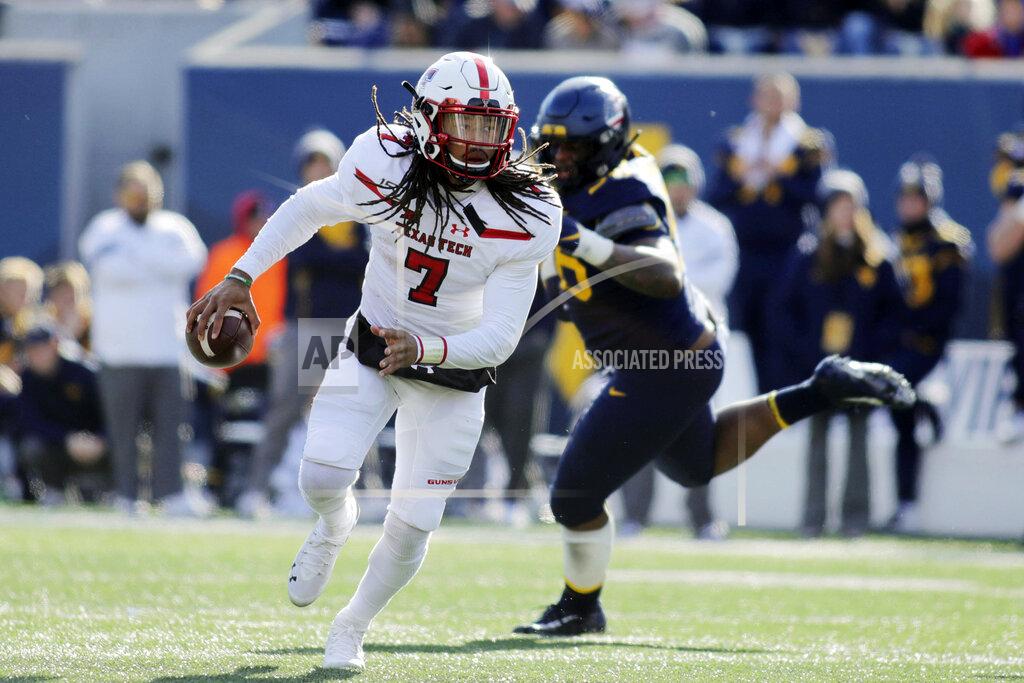 Chris Jackson Texas Tech quarterback Jett Duffey (7) escapes from West Virginia's Darius Stills (56) during the third quarter of their NCAA college football game in Morgantown, W.Va., Saturday, Nov. 9, 2019. (AP Photo/Chris Jackson)
