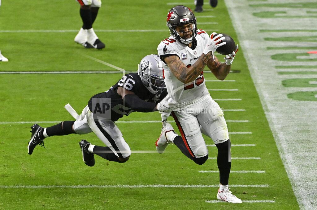 David Becker Las Vegas Raiders cornerback Nevin Lawson (26) pushes Tampa Bay Buccaneers wide receiver Mike Evans (13) out of bounds during the second half of an NFL football game, Sunday, Oct. 25, 2020, in Las Vegas. (AP Photo/David Becker)