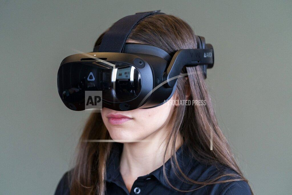 Jacquelyn Martin A VR helmet that is used with a version of the TASER 7 that utilizes VR technology for training, is demonstrated, Thursday, May 12, 2022, in Washington. Axon, the company that is best known for developing the Taser, is expanding virtual reality and immersive training in an effort to encourage police officers across the U.S. to more regularly train with less-than-lethal weapons. (AP Photo/Jacquelyn Martin)