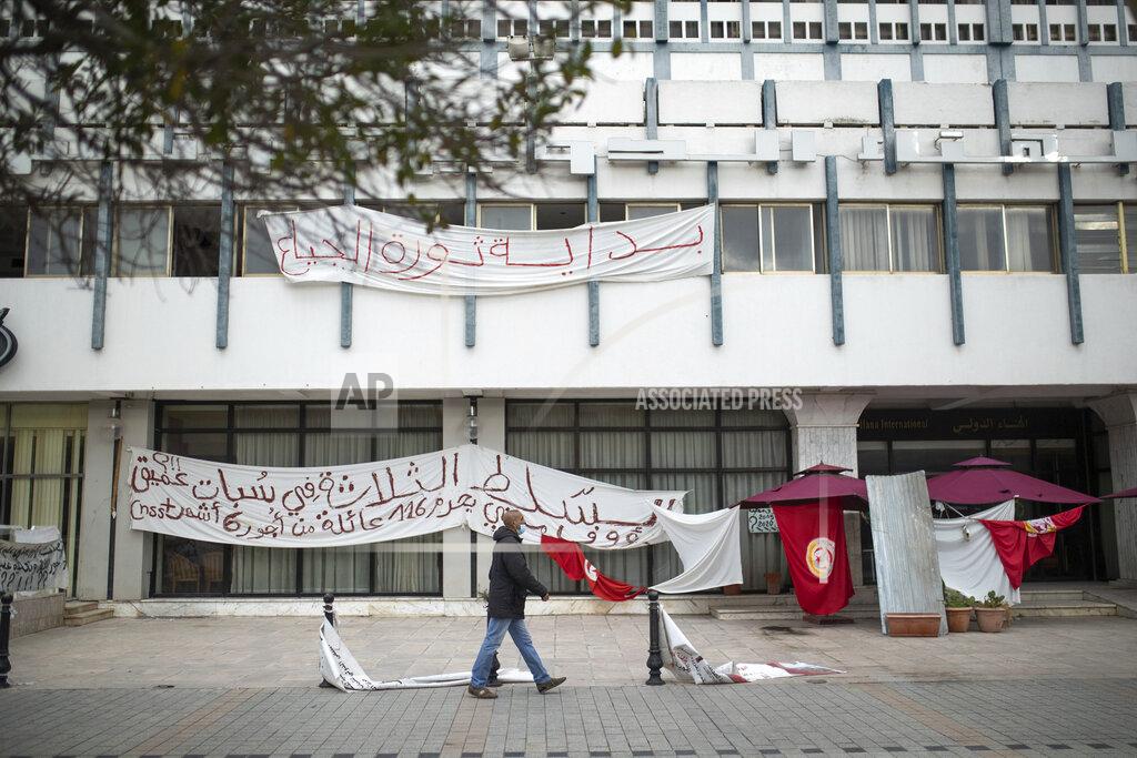 Mosa'ab Elshamy A man walks past an empty sit-in due to a national lockdown in Tunis' landmark Avenue Habib Bourgiba, where massive protests took place in 2011, on the tenth anniversary of the uprising , in Tunis, Thursday, Jan. 14, 2021. Tunisia is commemorating the 10th anniversary since the flight into exile of its iron-fisted leader, Zine El Abidine Ben Ali, pushed from power in a popular revolt that foreshadowed the so-called Arab Spring. But there will be no festive celebrations Thursday marking the revolution in this North African nation, ordered into lockdown to contain the coronavirus. (AP Photo/Mosa'ab Elshamy)