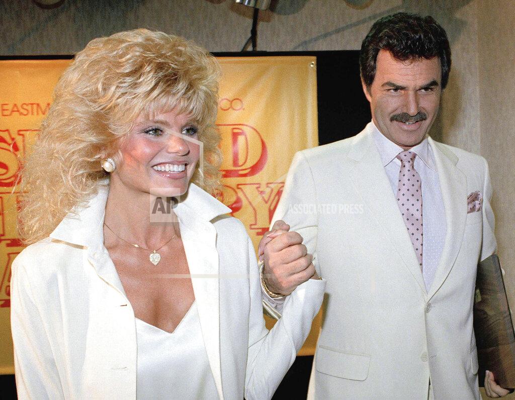 Bob Galbraith FILE - In this March 27, 1987, file photo, Burt Reynolds, right, holds hands with Loni Anderson at luncheon in Los Angeles. (AP Photo/Bob Galbraith, File)