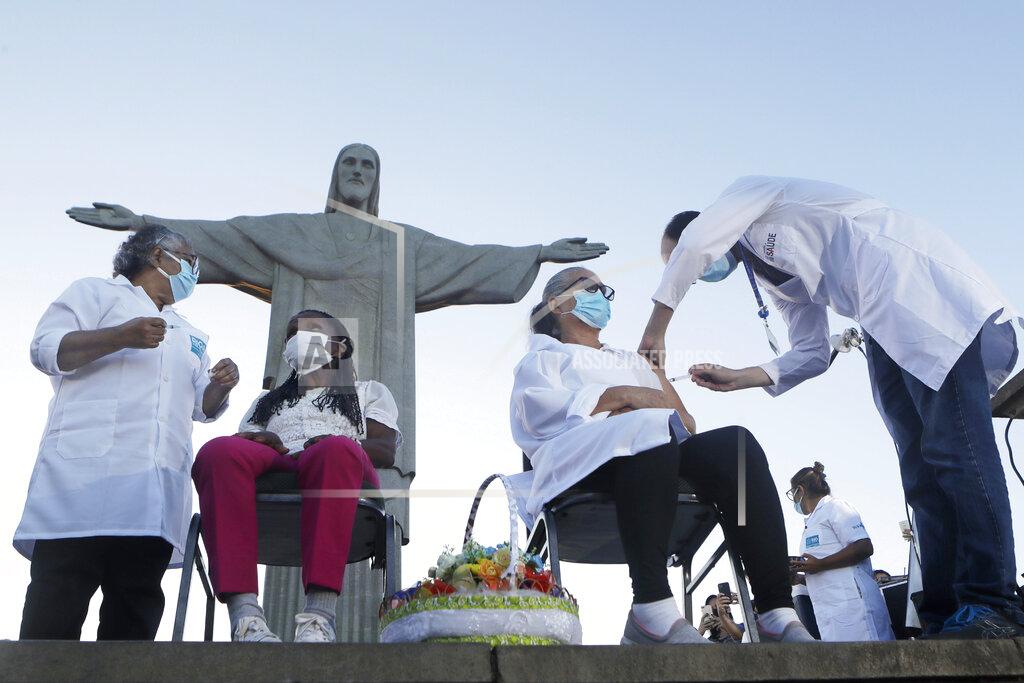 Bruna Prado FILE - In this Monday, Jan. 18, 2021, file photo, Terezinha da Conceicao, 80, left, and Dulcinea da Silva Lopes, 59, become the first women in the country to receive the COVID-19 vaccine produced by China's Sinovac Biotech Ltd, during the start of the vaccination program in front of the Christ the Redeemer statue in Rio de Janeiro, Brazil. China’s vaccine diplomacy campaign has pledged roughly half a billion doses of its vaccines to dozens of countries. (AP Photo/Bruna Prado, File)